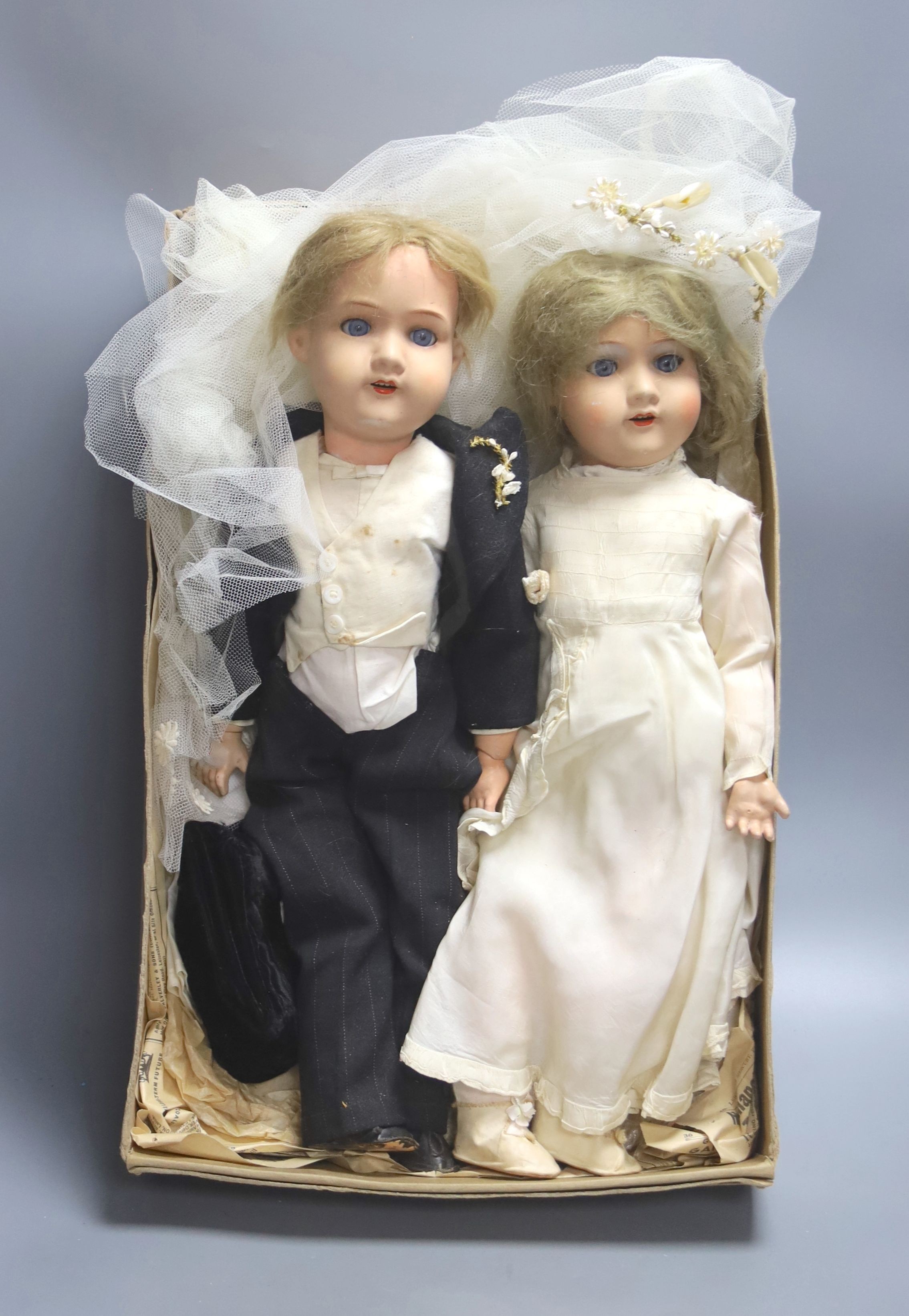 A pair of Armand Marseille 390 bisque head groom and bride dolls, tallest 50cm